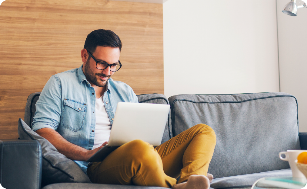 Man using laptop sitting on couch