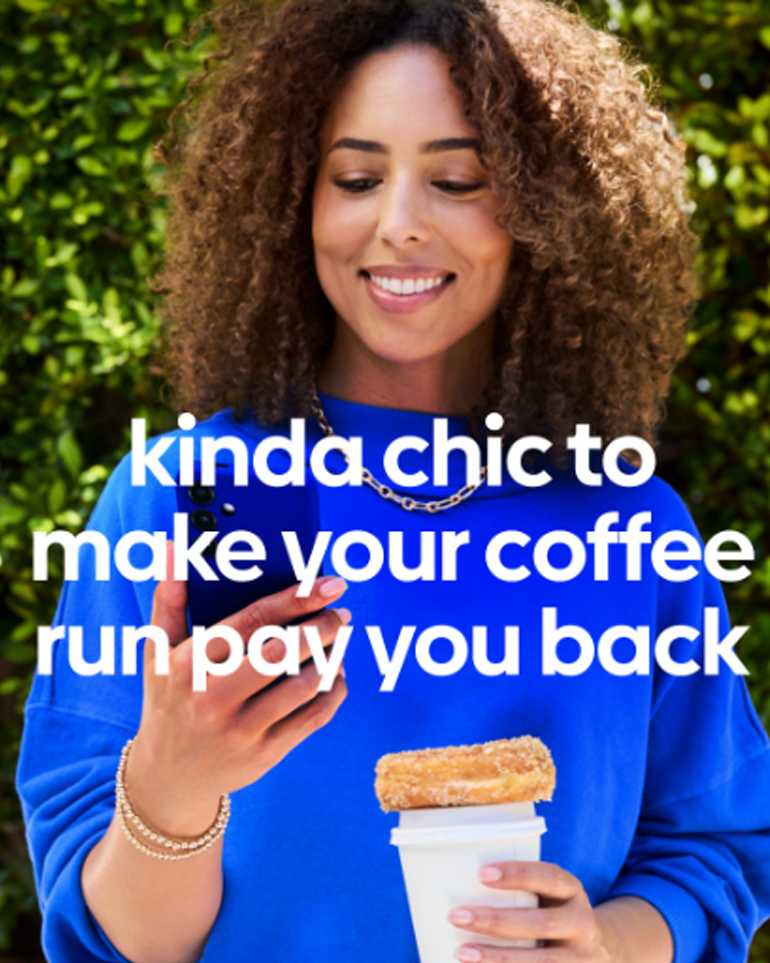 A woman holding a phone, coffee, and donut. Text overlayed kinda chic to make your coffee run pay you back.
