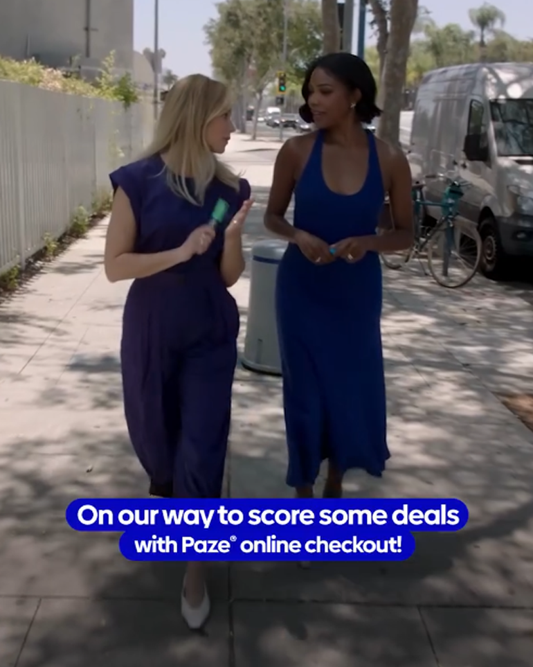 Elizabeth Banks and Gabrielle Union walking on a sidewalk. Text overlayed on our way to score some deals with Paze online checkout.